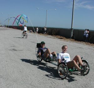 The typical 'recumbent grin' as 
two women enjoy a test ride on a Greenspeed tandem recumbent trike, 
during the Ride Across the Chesapeake Bay Bridge/Tunnel 2001